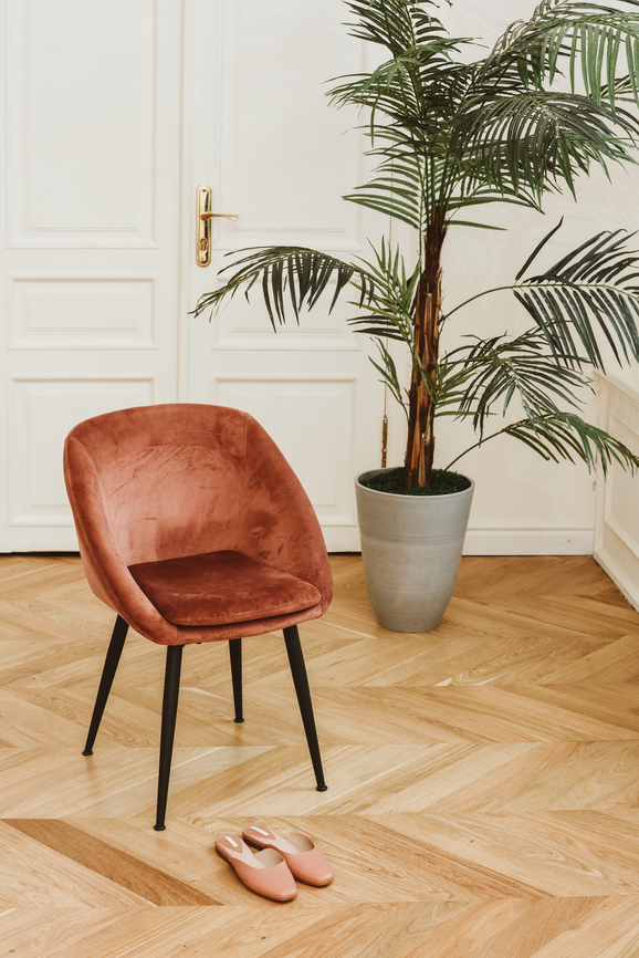 interior design pink velvet mid century modern chair palm parquet floors