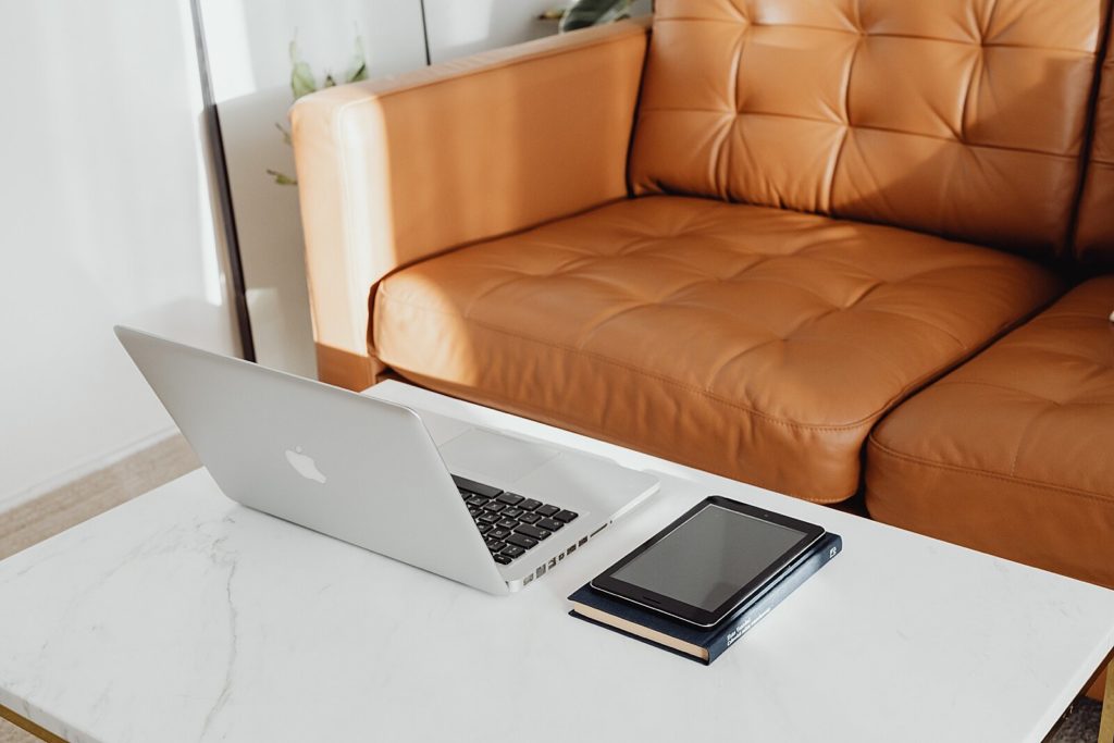 leather sofa laptop on desk how to get testimonials for interior designers copywriter
